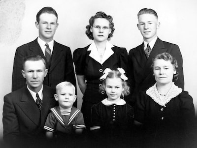 a black and white photo of a family